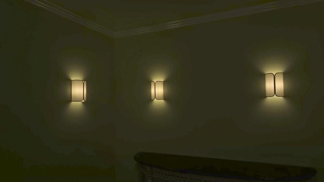 Exterior architectural wall sconces illuminated at night