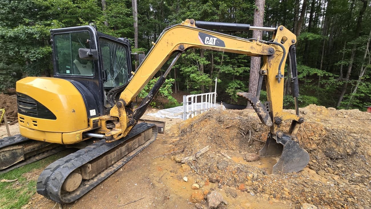 Mini excavator trenching for an underground electrical feeder